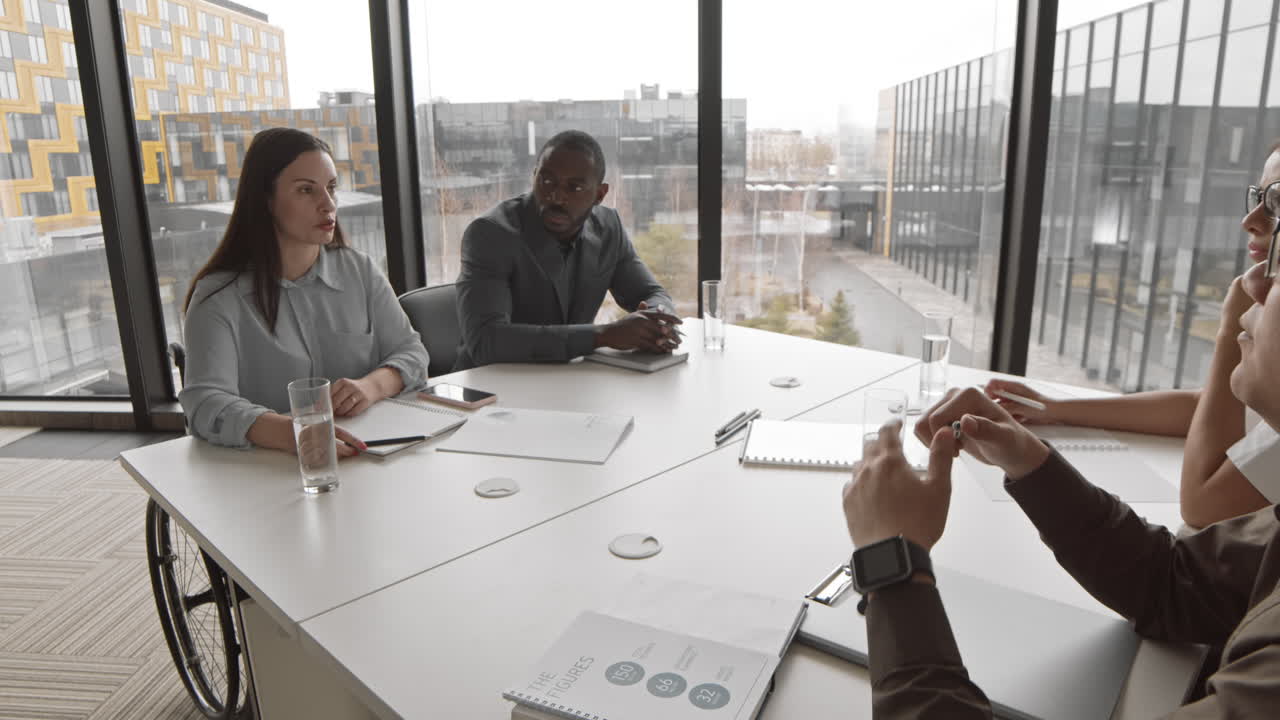 Female Head of Company with Disability Talking to Employees