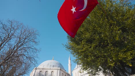 turkish flag flying over a mosque in istanbul