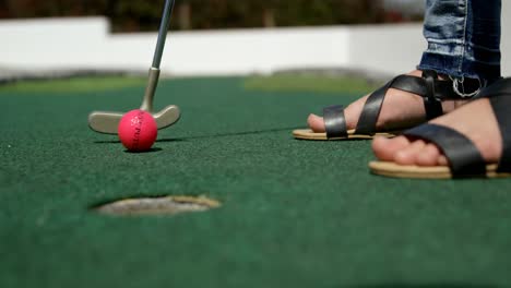 girl playing miniature golf in the garden 4k