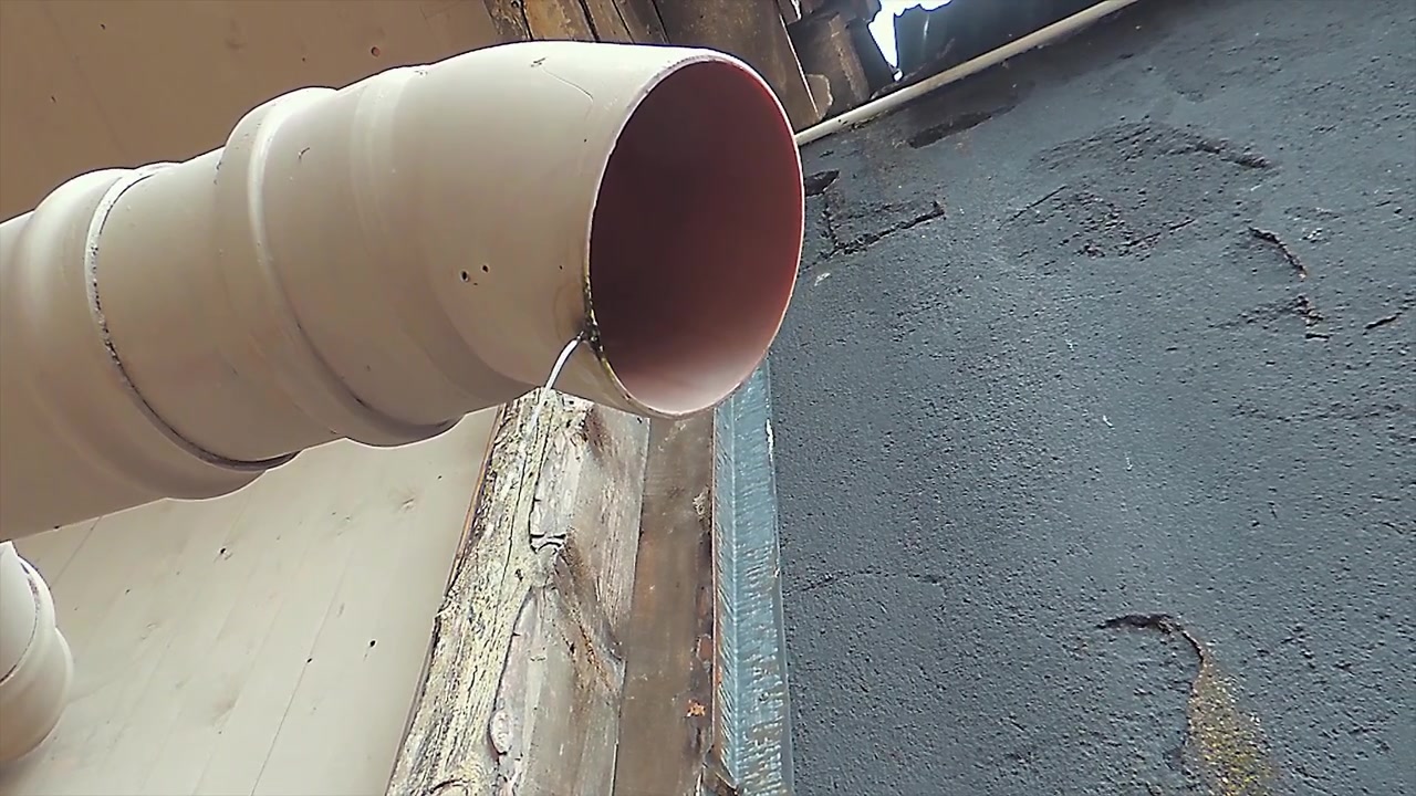 Rainwater is running through a broken downspout