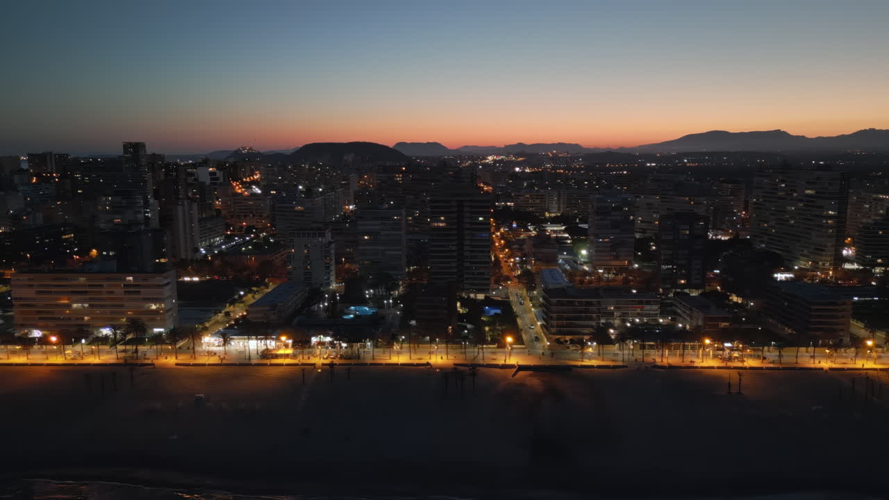 Aerial drone view of the Mediterranean Sea and the Alicante city in Spain at sunset