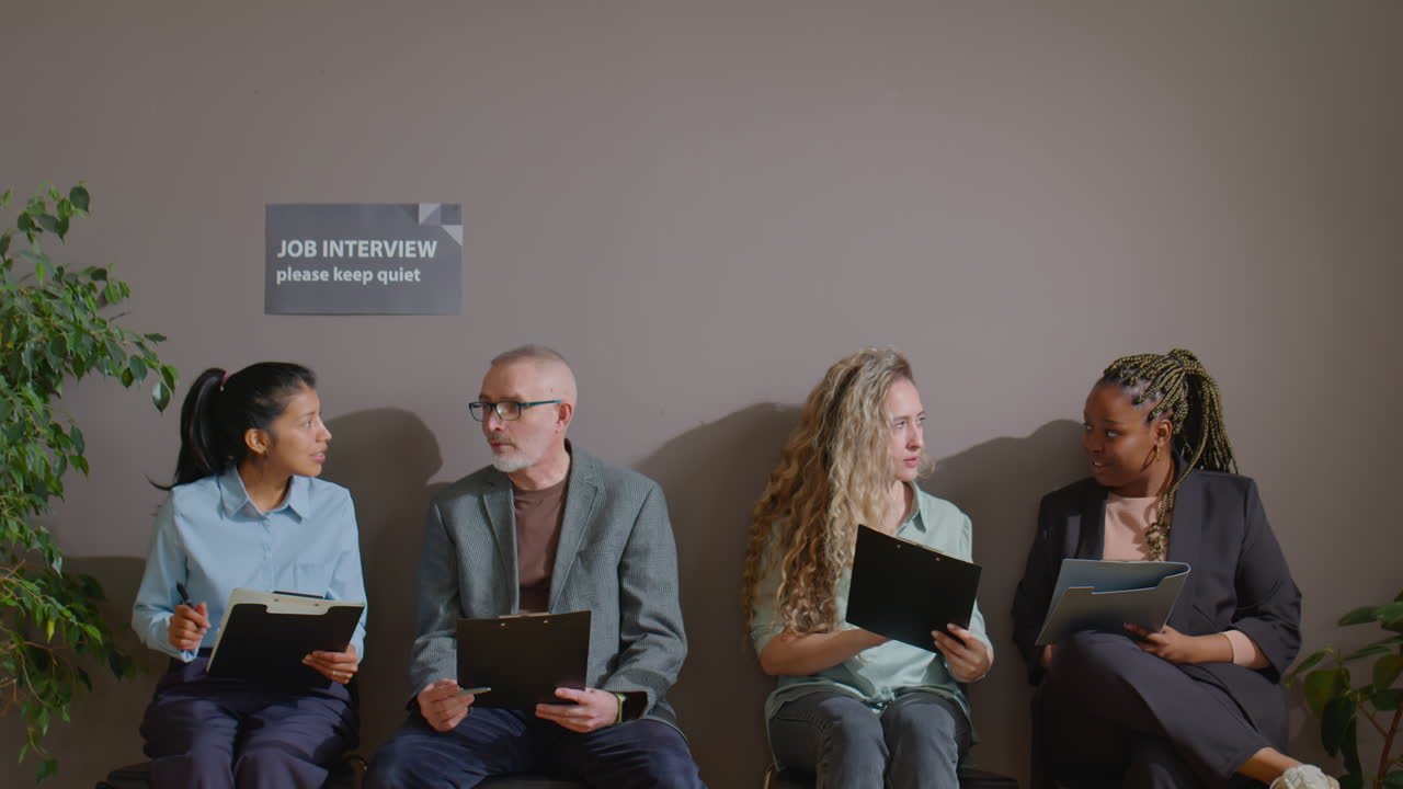 Job Candidates Chatting while Waiting In Queue for Interview