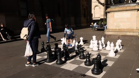 people playing giant chess in public square