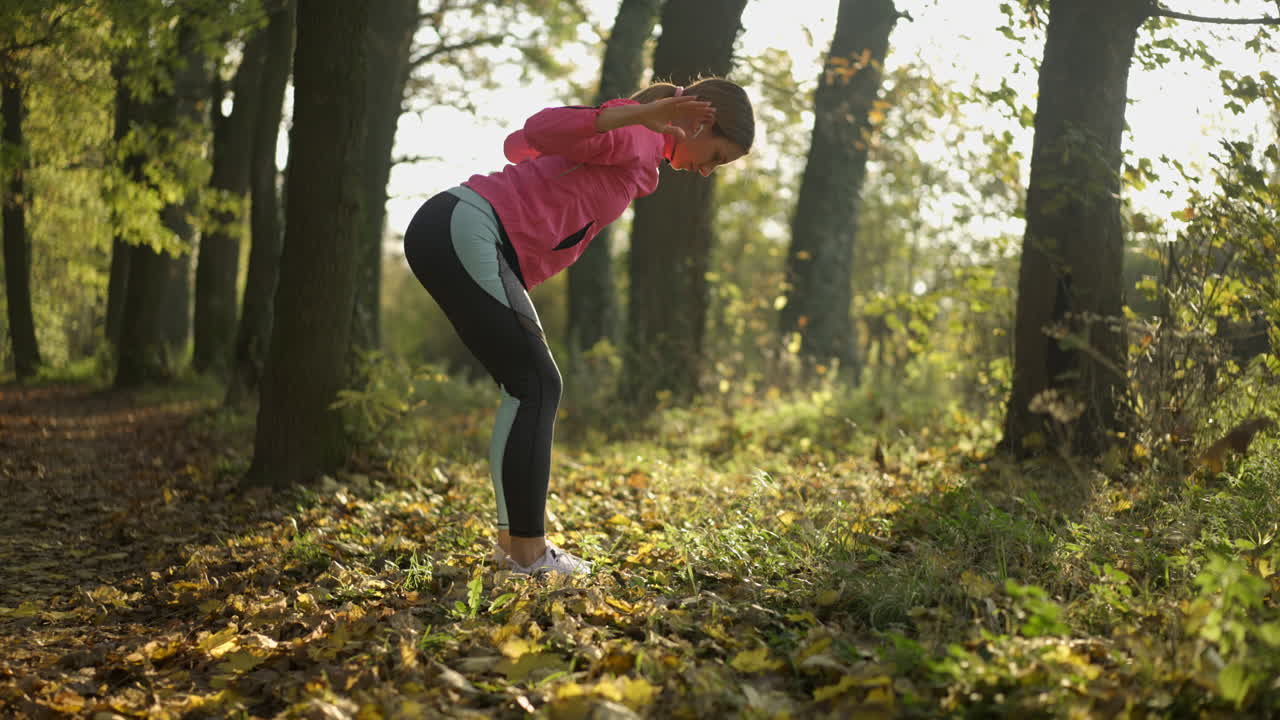 Woman Stretching in an Autumn Park