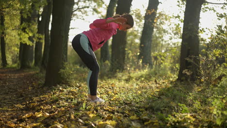 woman stretching in an autumn park