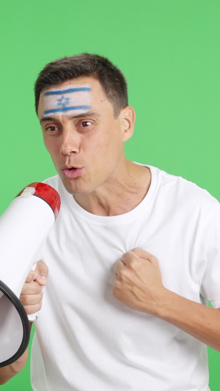 Excited man with israeli flag on face using a megaphone