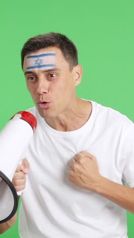 excited man with israeli flag on face using a megaphone