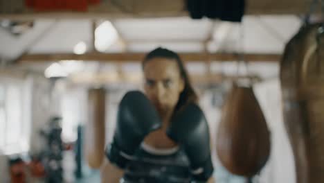 woman boxer punching towards camera