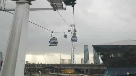point of view from moving cable car chairlift pulling up to station platform
