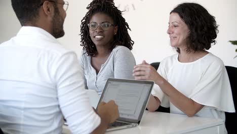 cheerful people shaking hands in office.