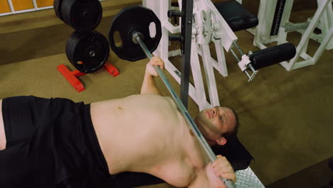 man lifting a heavy barbell