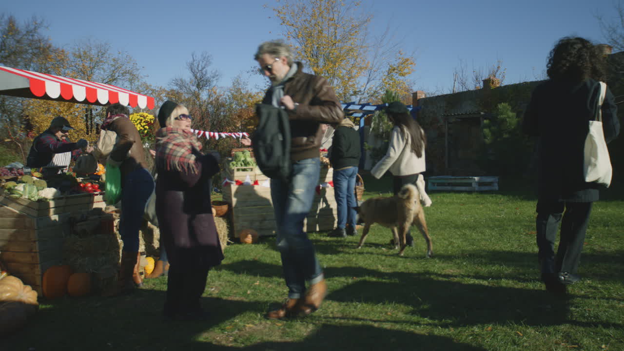 Diverse People Shopping at Local Farmers Market a Lot of Diverse People Walking Shopping Choosing Fruits and Vegetables at Local Farmers Market Autumn Fair on Weekend Outdoors Vegetarian and Organic Food Agriculture Points of Sale system