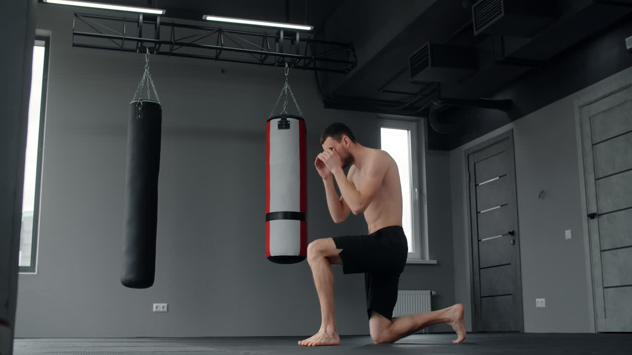 Man practicing Muay Thai in a gym