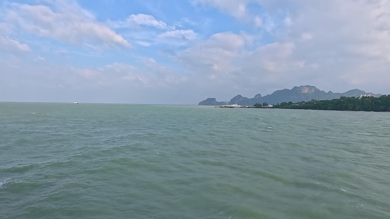 A tranquil 35-second video capturing the expansive sea and distant mountains of Koh Samui under a partly cloudy sky