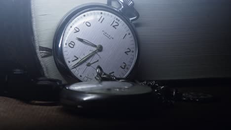 antique pocket watch on shelf shows time in smooth panning close-up