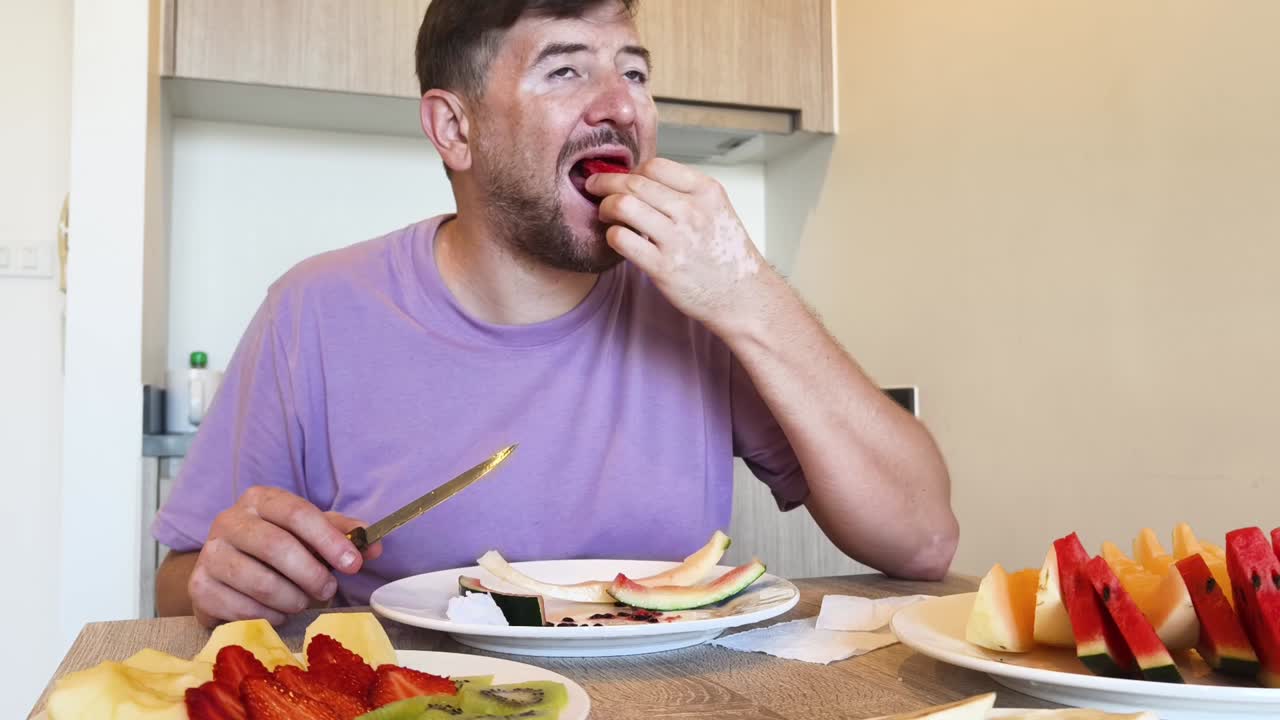 A man eating fruit at a table