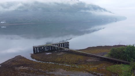 Old-Jetty-near-Abandoned-Torpedo-Range-Building-on-Loch-Long-near-Arrochar,-Scottish-Highlands,-West-Coast-of-Scotland---Aerial-Drone-4K-HD-Footage,-Circle