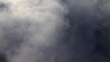 Aerial video from above the skies filming straight downwards at a layer of clouds