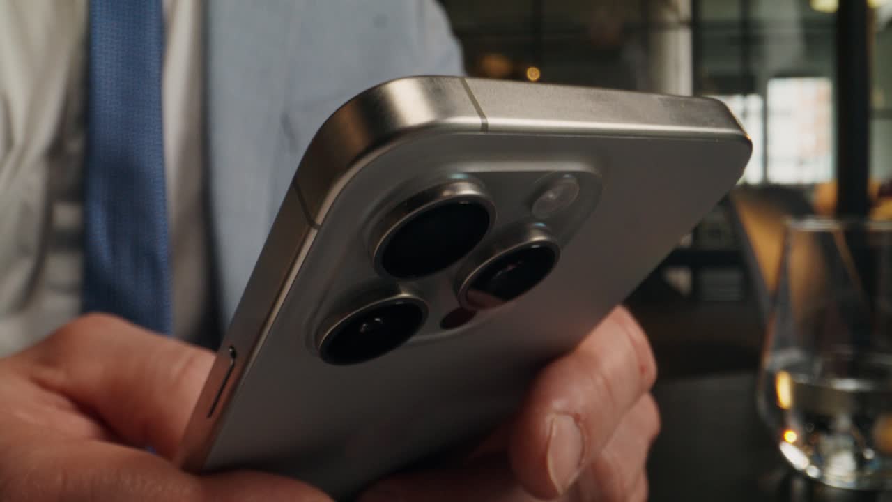 Business Man Using Phone and Laptop in Cafe