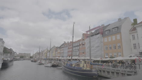 overview shot of nyhavn street in copehagen denmark on a cloudy day log