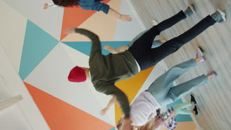 group of friends upside-down dancing in a colorful room