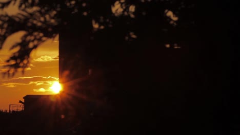 sliding shot reveals sunrise at rural farm