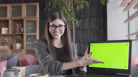 a presentable young lady shows a paper with schemes and diagrams of her new project