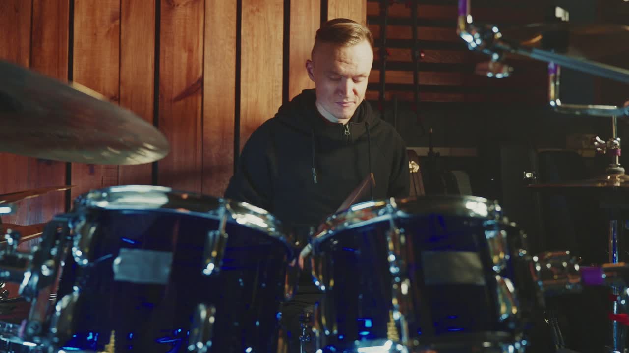 Drummer Playing Drums in a Studio