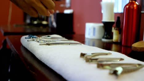Barber-arranging-barbering-tools-on-towel-4k