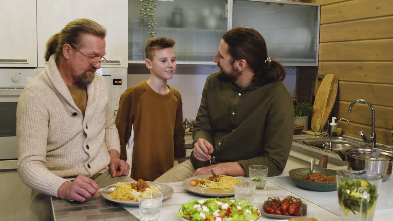 Caucasian men and boy in the kitchen