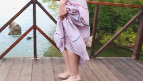 woman walking barefoot on wooden bridge