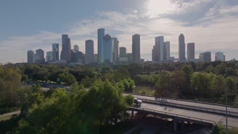 houston city skyline with urban park and bridge on a sunny day