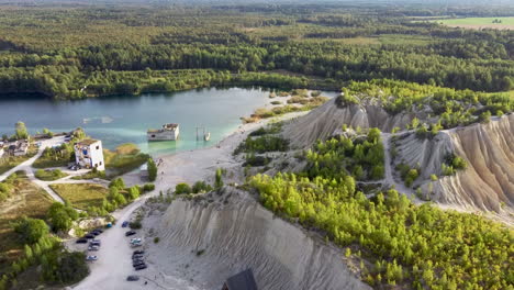 aerial landscape sand hills of quarry with a pond and abandoned prison in rummu estonia europe