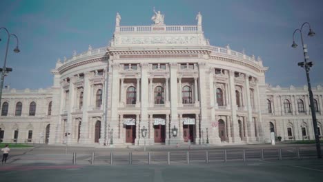 motion tilt up over empty street around historic burgtheater, austria