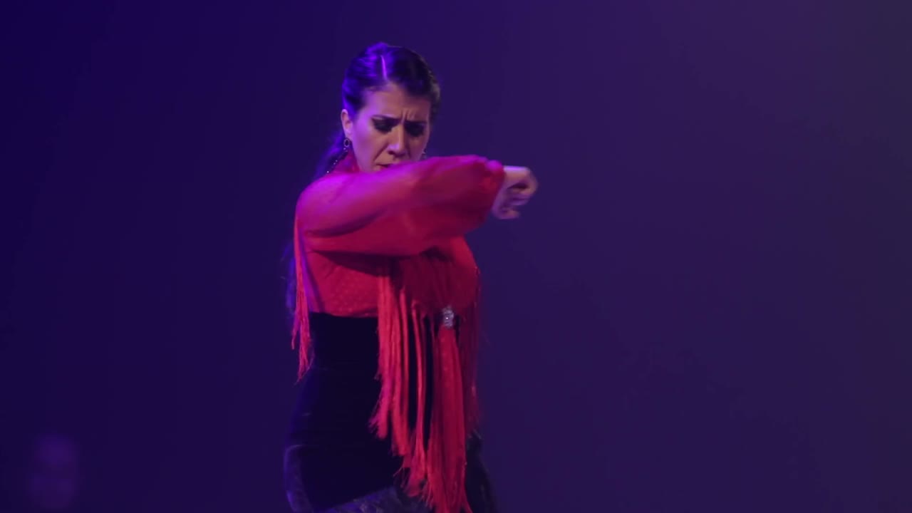 Close up of woman dancing flamenco on stage. Handheld