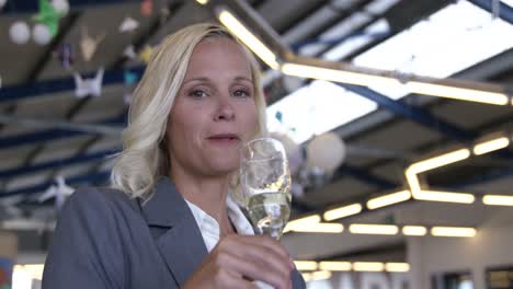 smiling businesswoman drinking champagne