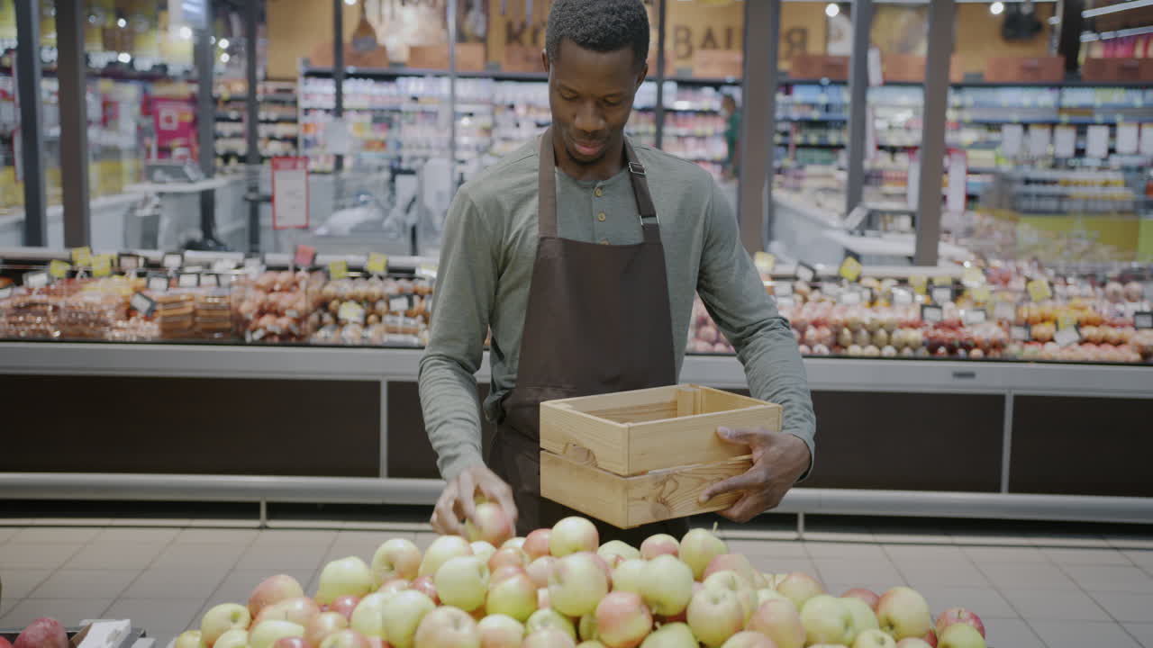 Grocery Store Employee Working with Apples