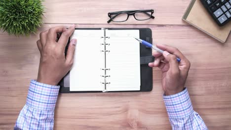 person writing in a notebook