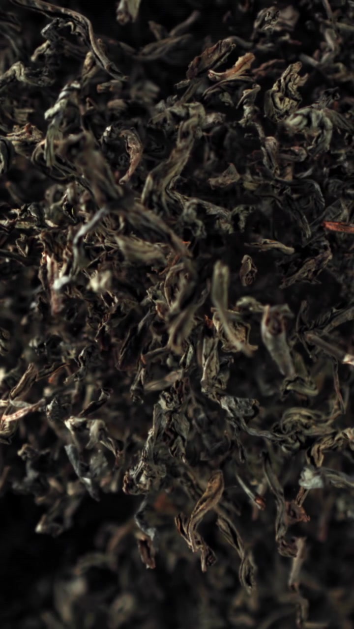 Slow Motion Zoom into Detailed Black Tea Leaves