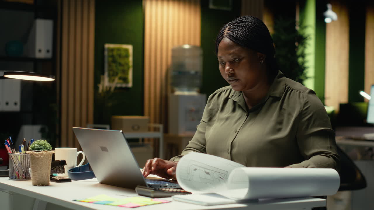 Black employee proofreading and fact checking financial numbers