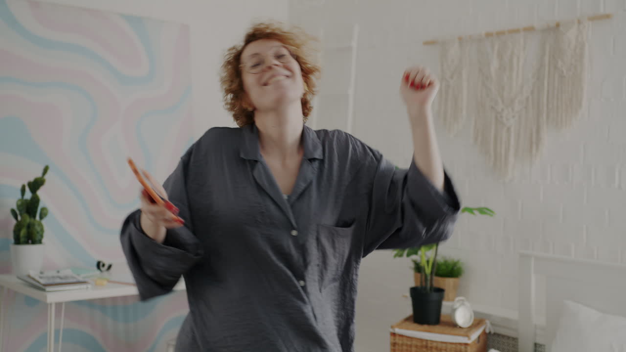 Woman Dancing in Pajamas in Bedroom