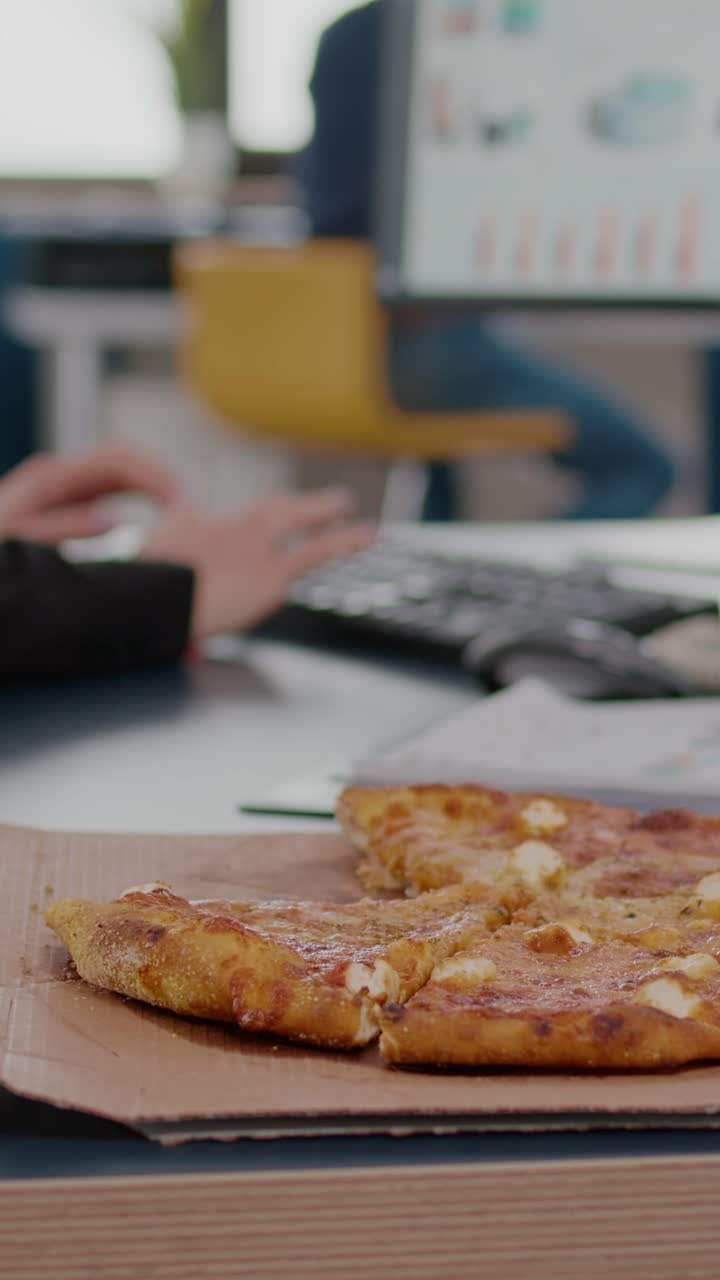 Vertical video: Closeup of businesswoman having fast food order takeout lunchtime working in startup company