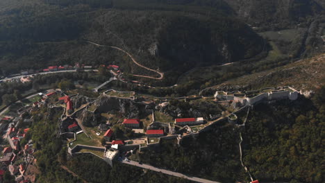 drone pushing backwards from the krka to reveal the olf, historic fortress of knin and the horizon.