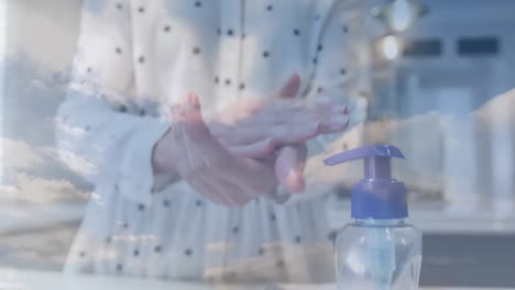 animation of caucasian woman disinfecting her hands over clouds