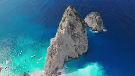 Drone-Shot-of-Rocks-and-White-Coastline-of-Zakynthos-Island-on-Sunny-Summer-Day