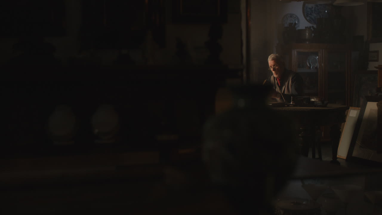 Old passionate man read a book in his office at night