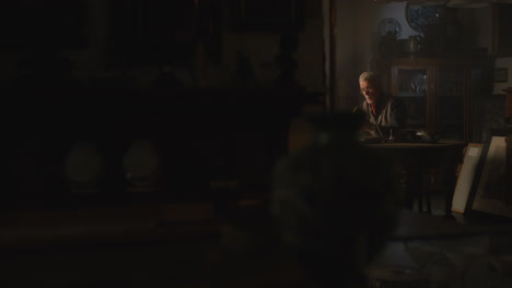 old passionate man read a book in his office at night
