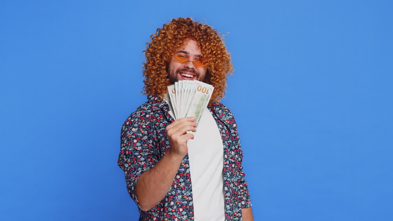 Rich happy man winner waving money dollar cash like a fan big income wealth success business