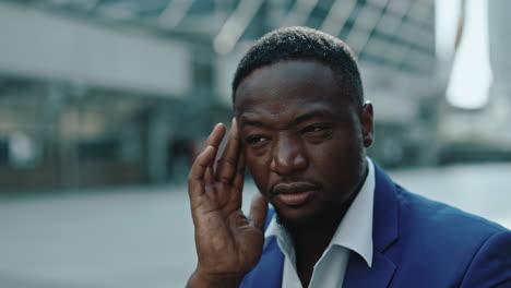 tired or stressed african american businessman outdoors