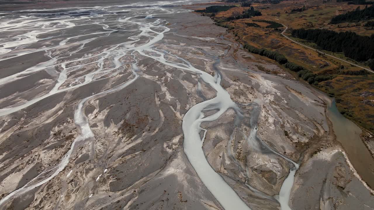 Brilliant tilt-up aerial reveal over river delta - Aoraki Mt Cook National Park